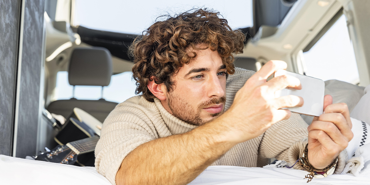 Man capturing an image during RV travels