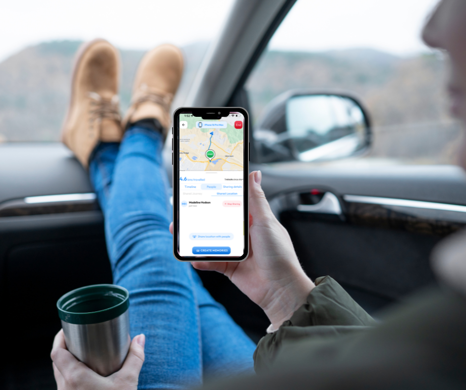Rver in a car with feet up, using the Routica Mobile App on a smartphone to view travel details.