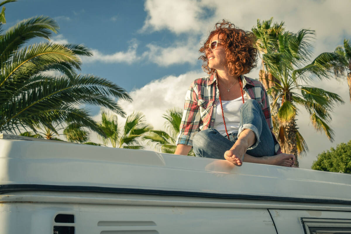 Woman enjoying RV travel near palm trees