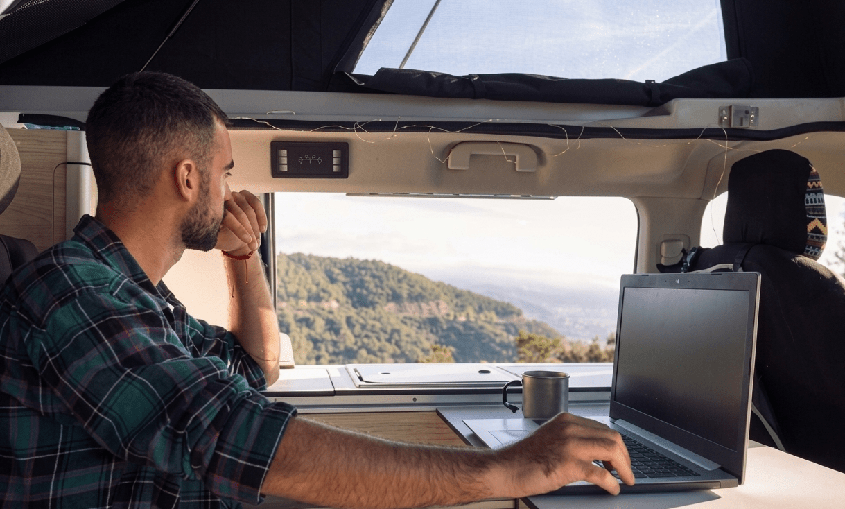 RVers crowded around devices at a campground struggling with slow campground Wi-Fi and weak cellular signal.